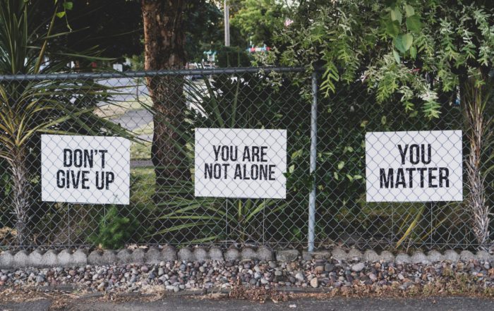 uplifting signs on fence