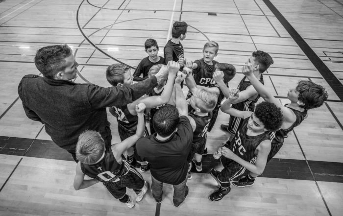 coach with team in huddle